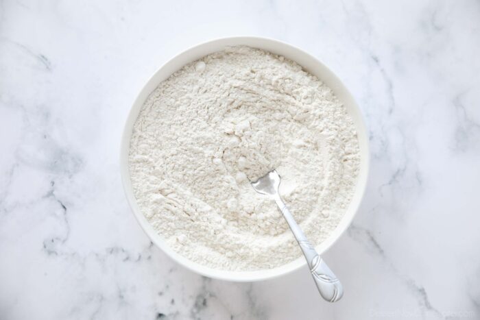 Flour mixture in a bowl, stirred with a fork.