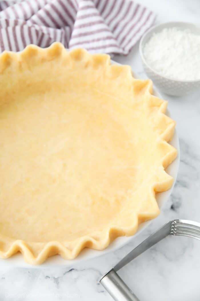 Close up of fluted edges of a shortening pie crust recipe.