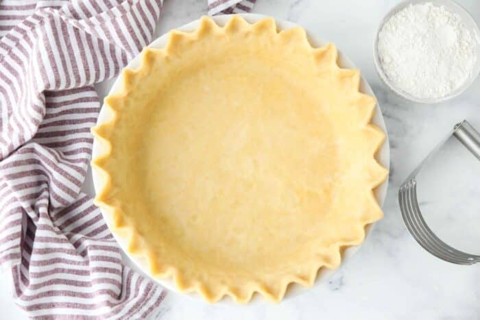 Top view of easy pie crust in a pan with fluted eges.