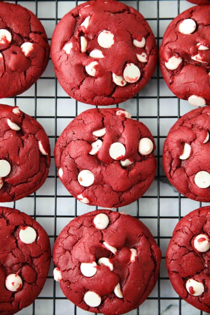 Red Velvet Cake Mix Cookies with white chocolate chips on a wire cooling rack.