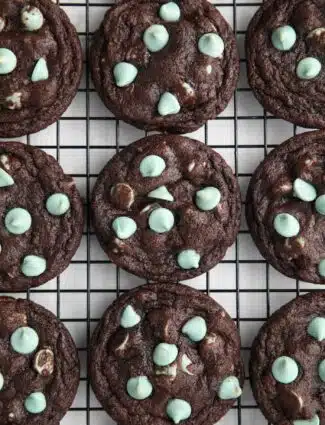 Fudgy chocolate mint chip cookies on a wire cooling rack.