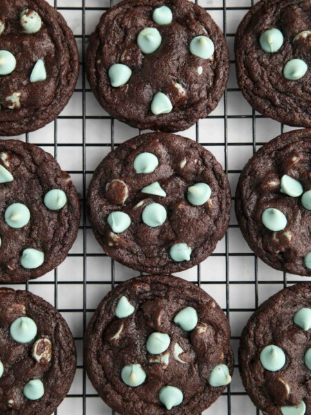 Fudgy chocolate mint chip cookies on a wire cooling rack.