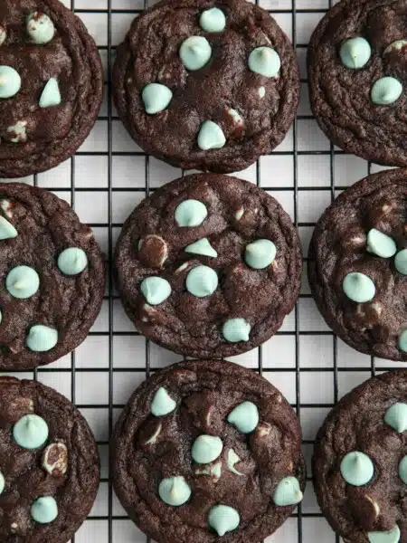 Fudgy chocolate mint chip cookies on a wire cooling rack.