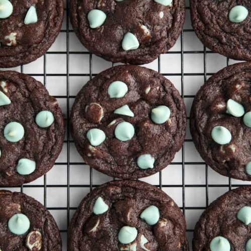 Fudgy chocolate mint chip cookies on a wire cooling rack.