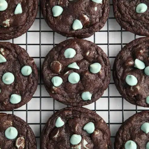 Fudgy chocolate mint chip cookies on a wire cooling rack.