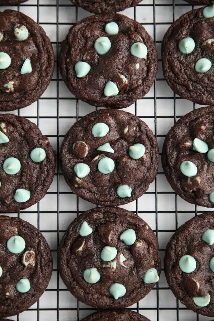 Fudgy chocolate mint chip cookies on a wire cooling rack.