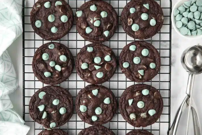 Fudgy chocolate mint chip cookies on a wire cooling rack.