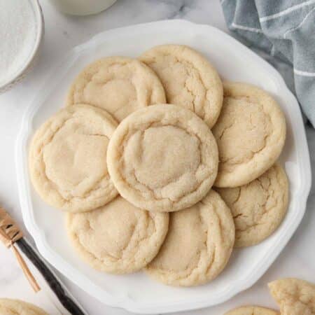 Easy Sugar Cookies on a plate. Chewy outside and soft inside.