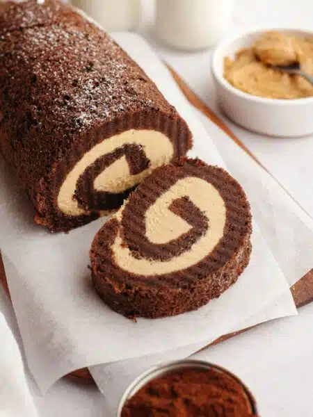 A slice cut off the end of a chocolate roll cake with peanut butter filling.