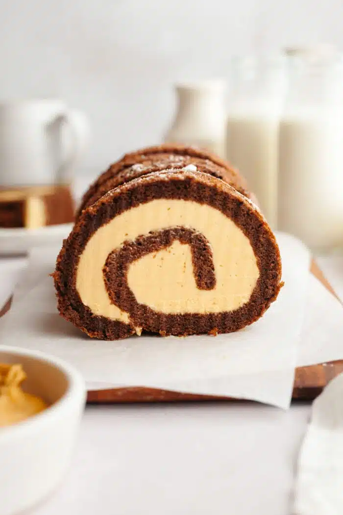 Side view of a chocolate peanut butter roll showing the swirls of cake and frosting.