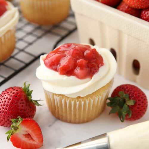 Valentine cupcakes made with strawberry sauce, whipped cream cheese frosting, and vanilla cake.