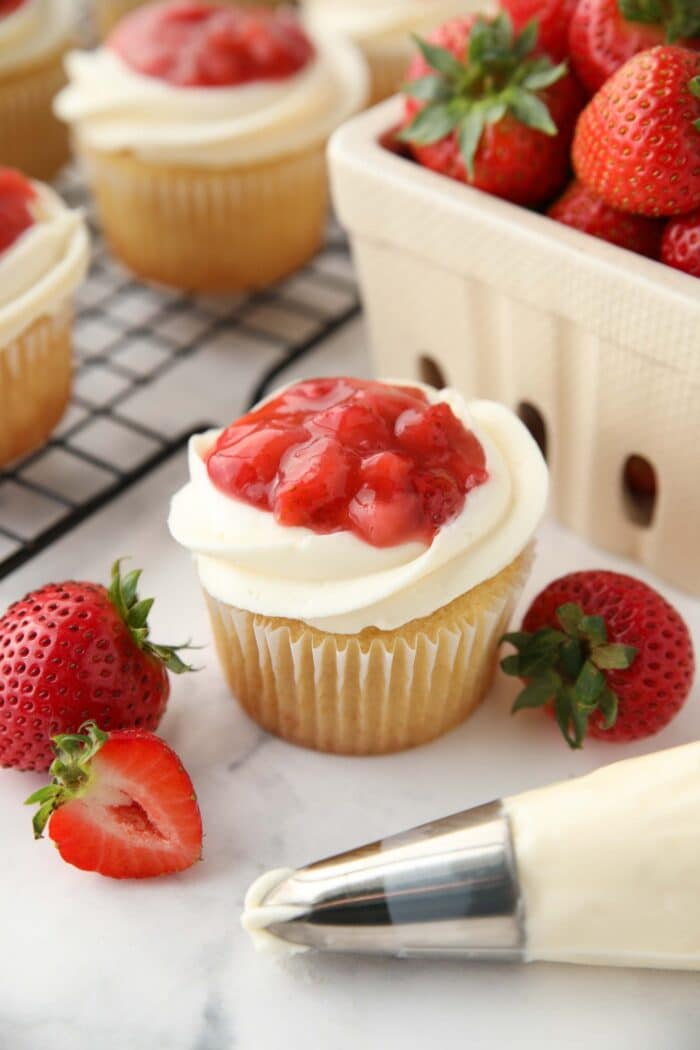 Valentine cupcakes made with strawberry sauce, whipped cream cheese frosting, and vanilla cake.